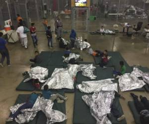 This US Customs and Border Protection photo dated June 17, 2018 obtained June 18, 2018 shows intake of illegal border crossers by US Border Patrol agents at the Central Processing Center in McAllen, Texas.Children have been taken away from their mothers and fathers in the Border Patrols South Texas Rio Grande Valley sector, with many brought to the Central Processing Station in McAllen, Texas, since the policy was announced on May 7, according to Manuel Padilla, the Border Patrol sector chief. / AFP PHOTO / US Customs and Border Protection / Handout / RESTRICTED TO EDITORIAL USE - MANDATORY CREDIT 'AFP PHOTO / US CUSTOMS AND BORDER PROTECTION/HANDOUT' - NO MARKETING NO ADVERTISING CAMPAIGNS - DISTRIBUTED AS A SERVICE TO CLIENTS / The erroneous mentions appearing in the metadata of this photo by the US Customs and Border Protection has been modified in AFP systems in the following manner: [photo dated June 17, 2018 and obtained June 18, 2018] and not as previously stated. Please immediately remove the erroneous mentions from all your online services and delete them from your servers. If you have been authorized by AFP to distribute them to third parties, please ensure that the same actions are carried out by them. Failure to promptly comply with these instructions will entail liability on your part for any continued or post notification usage. Therefore we thank you very much for all your attention and prompt action. We are sorry for the inconvenience this notification may cause and remain at your disposal for any further information you may require.