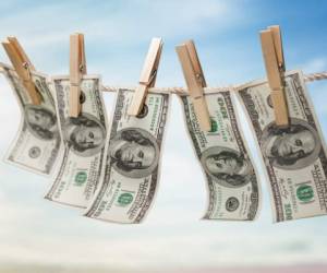 Money Laundering. Hanging $100 bills