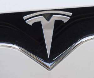 (FILES) In this file photo taken on December 20, 2016 the Tesla logo is seen in Washington, DC. - Tesla was sued January 8, 2019 by the family of a passenger killed in a 2018 crash which they allege was due to a defective car battery, attorneys said. Tesla has come under scrutiny, and faced multiple lawsuits, for other crashes involving its high-tech cars, but those largely have involved issues with the Autopilot semi-autonomous driving feature. (Photo by SAUL LOEB / AFP)