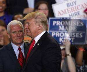 HARRISBURG, PA - APRIL 29: U.S. President Donald Trump (R) is introduced by Vice President Mike Pence (L) during a 'Make America Great Again Rally' at the Pennsylvania Farm Show Complex & Expo Center April 29, 2017 in Harrisburg, Pennsylvania. President Trump held a rally to mark his first 100 days of his presidency. Alex Wong/Getty Images/AFP