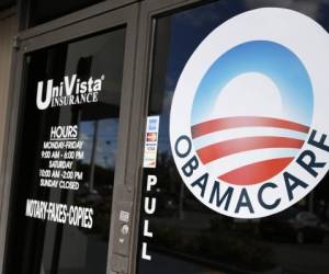 An Obamacare logo is shown on the door of the UniVista Insurance agency in Miami, Florida on January 10, 2017. - As President-elect Donald Trump's administration prepares to take over Washington, they have made it clear that overturning and replacing the Affordable Care Act is a priority. (Photo by RHONA WISE / AFP)
