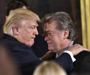 (FILES) This file photo taken on January 22, 2017 shows US President Donald Trump (L) congratulating Senior Counselor to the President Stephen Bannon during the swearing-in of senior staff in the East Room of the White House on January 22, 2017 in Washington, DC.Steve Bannon, President Donald Trump's chief strategist, has lost his seat on the powerful National Security Council on April 05, 2017 in an apparent high-level shakeup, a US official confirmed. / AFP PHOTO / MANDEL NGAN