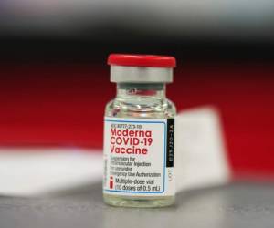 A vial of the COVID-19 vaccine from Moderna sits on a table top to be used in vaccinating employees in the first round of staff vaccinations at Rose Medical Center Wednesday, Dec. 23, 2020, in Denver. (AP Photo/David Zalubowski)