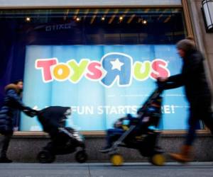People pass by the Toys R Us store at Times Square in New York, U.S., March 9, 2018. REUTERS/Eduardo Munoz