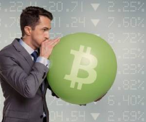Businessman blowing bubble with Bitcoin sign. Financial bubble concept.