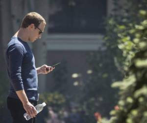 SUN VALLEY, ID - JULY 13: Mark Zuckerberg, chief executive officer of Facebook, checks his phone during the annual Allen & Company Sun Valley Conference, July 13, 2018 in Sun Valley, Idaho. Every July, some of the world's most wealthy and powerful businesspeople from the media, finance, technology and political spheres converge at the Sun Valley Resort for the exclusive weeklong conference. Drew Angerer/Getty Images/AFP