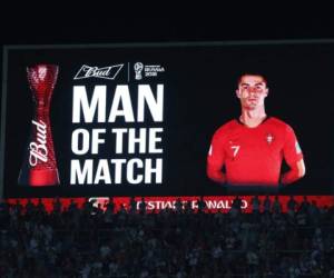 A screen displays an image of Portugal's forward Cristiano Ronaldo with the text 'Man of the Match' at the end of the Russia 2018 World Cup Group B football match between Portugal and Spain at the Fisht Stadium in Sochi on June 15, 2018. / AFP PHOTO / Adrian DENNIS / RESTRICTED TO EDITORIAL USE - NO MOBILE PUSH ALERTS/DOWNLOADS