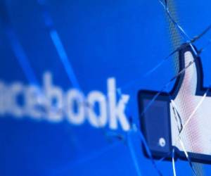 (FILES) In this file photo taken on May 16, 2018 shows the logo of the social network Facebook on a broken screen of a mobile phone. - Facebook said Thursday, November 15, 2018 it was severing ties with a political consultancy that sought to discredit critics of the social networking giant using questionable campaign-style tactics. The California-based company's announcement followed a lengthy New York Times investigation detailing Facebook's struggles with its image as it came under scrutiny for its handling of Russian-led misinformation efforts. Facebook said in a statement that 'we ended our contract' with Definers Public Affairs, which specializes in opposition research and, according to the Times, sought to link anti-Facebook efforts to financier George Soros. But Facebook disputed claims that it used the firm in a nefarious way. (Photo by JOEL SAGET / AFP)