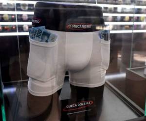 Pickpocket proof underwear, to carry hidden money is displayed at the 'Corruption Shop', a kiosk at Brasilia's Airport set up to promote the new Netflix series 'The Mechanism' (O Mecanismo), based on Brazil's mammoth 'Car Wash' graft scandal, on March 28, 2018. The kiosk which is part of an advertising campaign to promote 'O Mecanismo', a Brazilian drama series based on 'Lava Jato' (Car Wash), the largest anti-corruption investigation in Brazil's history, that involves private and state-owned oil and construction companies -on air since March 23, 2018- displays items which supposedly facilitate the life of corrupt persons. / AFP PHOTO / EVARISTO SA