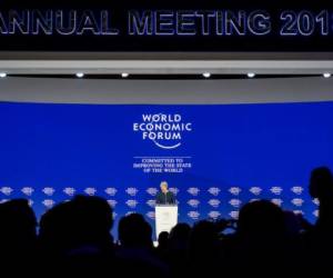 Britain's Prime Minister Theresa May addresses the Economic Forum (WEF) annual meeting on January 25, 2018 in Davos, eastern Switzerland. / AFP PHOTO / Fabrice COFFRINI