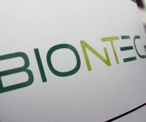 The logo of German company Biontech is pictured at the company's headquarters in Mainz, western Germany, on November 12, 2020. - The small German biotech firm BioNTech, started by a husband and wife team with Turkish roots, has never brought a vaccine to market before. But its experimental technology has now put it in pole position in the global race to develop a jab that will end the coronavirus crisis. (Photo by Daniel ROLAND / AFP)