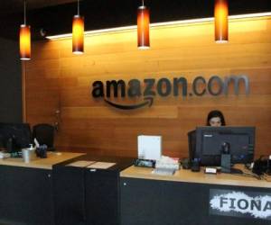 Nikol Szymul staffs a reception desk at Amazon offices discretely tucked into a building called Fiona in downtown Seattle, Washington on May 11, 2017. - Online retail powerhouse Amazon is constructing an eye-catching Spheres office building to feature waterfalls, tropical gardens and other links to nature as part of its urban campus in Seattle, Washington. (Photo by Glenn CHAPMAN / AFP)
