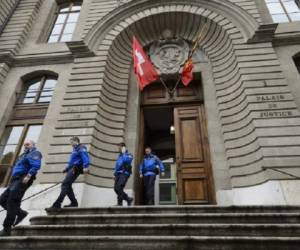 Police officers leave the Geneva's courthouse on May 4, 2015 during an appeal of Guatemala's former police chief Erwin Sperisen who last year received a life sentence in Switzerland for seven murders committed in the Central American country. Sperisen, 43, a Swiss and Guatemalan citizen who left his homeland for Geneva, was charged over the summary execution and subsequent cover-up of the murder of inmates in a jail in 2006. AFP PHOTO / FABRICE COFFRINI