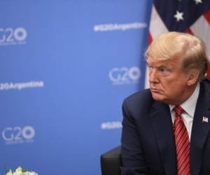 US President Donald Trump gestures during a bilateral meeting with Germanys Chancellor Angela Merkel, on the sidelines of the G20 Leaders' Summit in Buenos Aires, on December 01, 2018. - Trump canceled a press conference planned for Saturday at the G20 summit, saying he wanted to show respect to the family of late president George H.W. Bush. (Photo by SAUL LOEB / AFP)