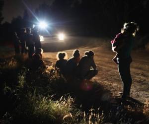 (FILES) In this file photo taken on June 11, 2018 showing U.S. Border Patrol agents arriving to detain a group of Central American asylum seekers near the U.S.-Mexico border in McAllen, Texas. Up to June 22, 2018, numerous photos and videos have been circulating on social media since the United States began implementing President Donald Trump's zero-tolerance policy towards illegal immigrants, leading more than 2,300 children to be separated from their parents. / AFP PHOTO / GETTY IMAGES NORTH AMERICA / John MOORE