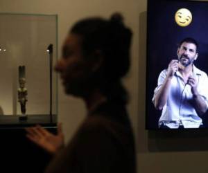 Curator Shirly Ben-Dor Evian presents the exhibition 'Emoglyphs: Picture-Writing from Hieroglyphs to the Emoji' at the Israel Museum in Jerusalem, on December 19, 2019. - The exhibition, open until late 2020, aims to convey the importance of ancient hieroglyphics to modern audiences glued to their phones through the cunning use of emojis, by comparing the pictograms of antiquity to those of today. (Photo by MENAHEM KAHANA / AFP)