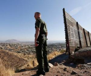A Border Patrol agent looks for footprints from illegal immigrants crossing the U.S.- Mexico border in 2010. Traffickers have begun using immigrants as drug smugglers, recruiting voluntarily and forcibly.