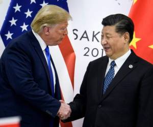 China's President Xi Jinping (R) shakes hands with US President Donald Trump before a bilateral meeting on the sidelines of the G20 Summit in Osaka on June 29, 2019. (Photo by Brendan Smialowski / AFP)