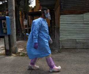 A funeral home worker in a protective suit picks up the body of a COVID-19 victim to take it to La Verbena cemetery in Guatemala City, on May 23, 2020 during the first of a two-day nationwide lockdown imposed by the government to contain the spread of the novel coronavirus. - The pandemic has killed at least 338,128 people worldwide since it surfaced in China late last year, according to an AFP tally at 1100 GMT on Saturday based on official sources. (Photo by Johan ORDONEZ / AFP)
