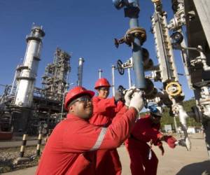 Operarios trabajan en la extractora de petróleo de Puerto La Cruz, ciudad de Anzoátegui, Venezuela. En junio de 2014, el crudo costaba US$104 el barril, hoy está en US$45.