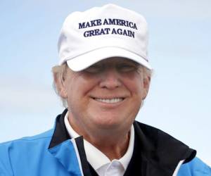 Presidential contender Donald Trump poses for the media during the third day of the Women's British Open golf championship on the Turnberry golf course in Turnberry, Scotland, Saturday, Aug. 01, 2015. (AP Photo/Scott Heppell)