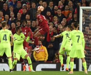 Liverpool's Dutch midfielder Georginio Wijnaldum (C) heads the ball to score their third goal during the UEFA Champions league semi-final second leg football match between Liverpool and Barcelona at Anfield in Liverpool, north west England on May 7, 2019. (Photo by Oli SCARFF / AFP)