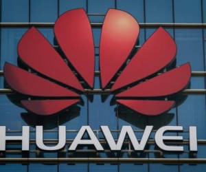 The Huawei logo stands on a Huawei office building in Dongguan in Chinas southern Guangdong province on December 18, 2018. (Photo by Nicolas ASFOURI / AFP)