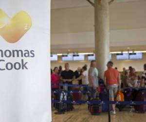 A banner of British travel firm Thomas Cook is seen at Punta Cana's international airport, in the Dominican Republic, on September 23, 2019. - British travel firm Thomas Cook, both a tour operator and an airline, collapsed on Monday leaving hundreds of thousands of holidaymakers stranded worldwide and sparking the UK's biggest repatriation since World War II. (Photo by Erika SANTELICES / AFP)