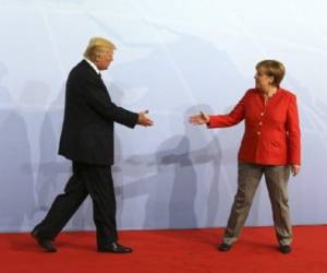 German Chancellor Angela Merkel greets US President Donald Trump at the start of the G20 meeting in Hamburg, northern Germany, on July 7.Leaders of the world's top economies will gather from July 7 to 8, 2017 in Germany for likely the stormiest G20 summit in years, with disagreements ranging from wars to climate change and global trade. / AFP PHOTO / AFP PHOTO AND POOL / LUDOVIC MARIN / SOLELY FOR REUTERS