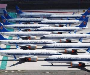 (FILES) In this file photo taken on June 05, 2019 shows grounded China Southern Airlines Boeing 737 MAX aircraft parked in a line at Urumqi airport, in China's western Xinjiiang region. - Chastised by the top US aviation regulator, Boeing on December 12, 2019, at last acknowledged that its 727 MAX aircraft will not return to the skies until next year. (Photo by GREG BAKER / AFP)