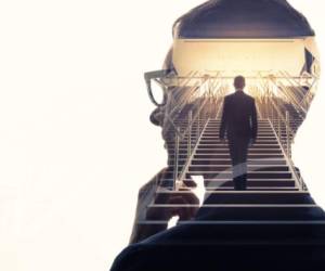 Double exposure of a businessman and stairs. Success of business concept.