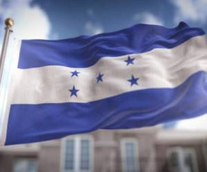 A member of the opposition holds up the national flag of Honduras while participating in a caravan along Morazan Boulevard to demand the resignation of President Juan Orlando Hernandez, in Tegucigalpa, on July 15, 2020. - The opposition accuses the government of corruption in the purchase of seven mobile hospitals, equipment and biosecurity material to fight the novel Coronavirus, which so far has left more than 800 dead and 29,106 infected. (Photo by ORLANDO SIERRA / AFP)