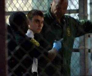 This video screen grab image shows shooting suspect Nikolas Cruz on February 15, 2018 at Broward County Jail in Ft. Lauderdale, Florida.The heavily armed teenager who gunned down students and adults at a Florida high school was charged Thursday with 17 counts of premeditated murder, court documents showed.Nikolas Cruz, 19, killed fifteen people in a hail of gunfire at Marjory Stoneman Douglas High School in Parkland, Florida. Two others died of their wounds later in hospital, the sheriff's office said. / AFP PHOTO / AFP TV / Miguel GUTTIEREZ