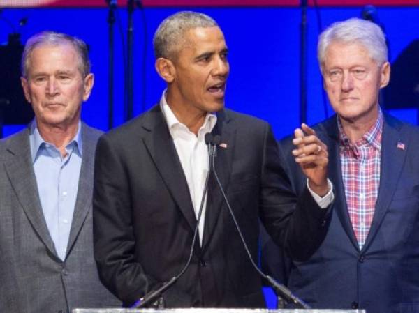 (FILES) In this file photo taken on October 21, 2017, (L-R) George W. Bush, Barack Obama and Bill Clinton attend the Hurricane Relief concert in College Station, Texas. - Obama, Bush and Bill Clinton are volunteering to take a coronavirus vaccine on camera if it will help promote public confidence. Obama, in an interview with SiriusXM radio, said he would be inoculated if top US infectious disease expert Anthony Fauci signs off on a Covid-19 vaccine. Freddy Ford, Bush's chief of staff, told CNN the former president also wanted to help promote vaccination. Angel Urena, Clinton's press secretary, told CNN the former president would also be willing to take a vaccine in public on television. (Photo by JIM CHAPIN / AFP)