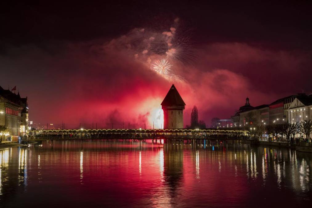 <i>Lucerna (Suiza Schweiz Suisse), 01/01/2025.- Los fuegos artificiales de Año Nuevo estallan sobre el Puente de la Capilla y el casco antiguo de Lucerna, Suiza, el 01 de enero de 2025. (Suiza, Lucerna) EFE/EPA/URS FLUEELER</i>