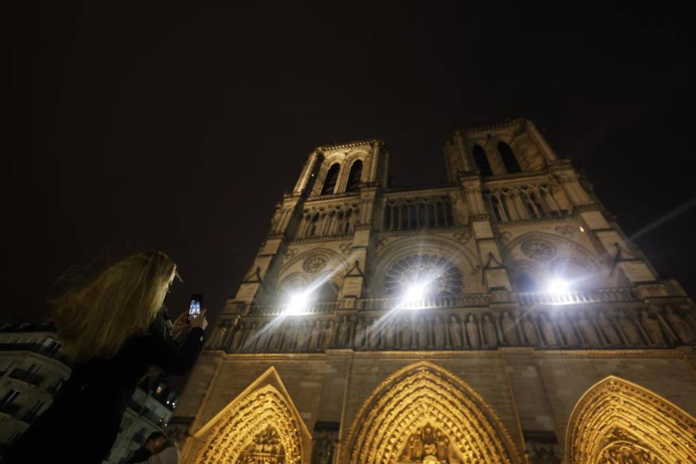 <i>Una mujer toma fotografías de la catedral de Notre Dame de París antes del inicio de la primera misa abierta al público en París, Francia, el 08 de diciembre de 2024. EFE/EPA/MOHAMMED BADRA</i>