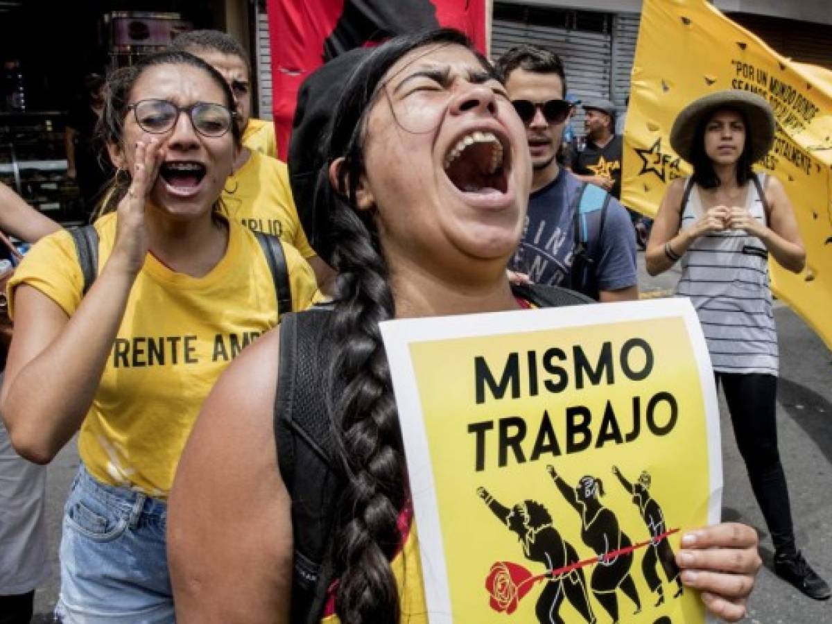Demonstrators shout slogans during a march of workers, university students and political activists to commemorate May Day, in San Jose on May 1, 2019. (Photo by Ezequiel BECERRA / AFP)
