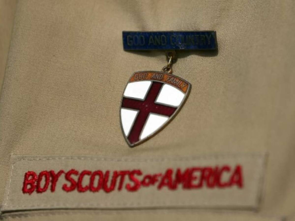 (FILES) In this file photograph taken on February 4, 2013, shows a detail of a Boy Scouts of America uniform in Irving, Texas. - The Boy Scouts of America filed for bankruptcy on February 18, 2020, in what it said was an effort to safeguard compensation payouts for sexual abuse victims. The organization has been accused of covering up generations of abuse inflicted on thousands of its young members and failing to do enough to root out pedophiles using the youth movement to prey on minors over its 110-year history. (Photo by TOM PENNINGTON / GETTY IMAGES NORTH AMERICA / AFP)