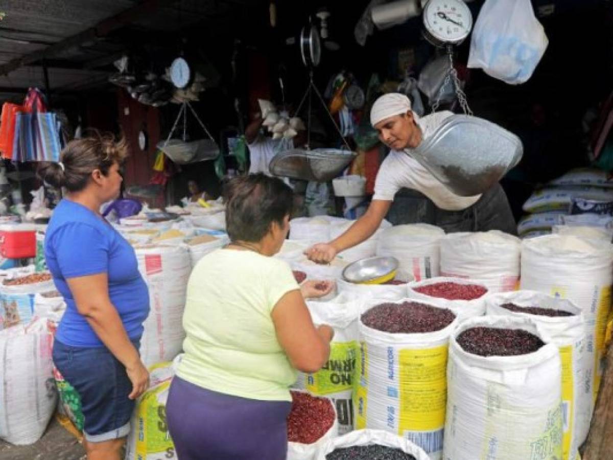 Sellers show basic grains to customers in Managua on January 26, 2018. Exports such as beans, corn and other basic grains from Nicaragua to Venezuela - political allies - shrank to close to nothing due to U.S. sanctions against the South American country, Nicaraguan sources reported. / AFP PHOTO / INTI OCON