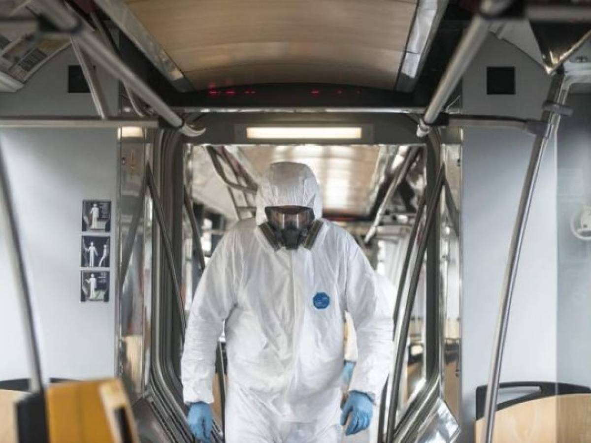 A worker walks in a tram during a test of new nano polymer disinfection as part of precautionary measures against the spread of the new coronavirus COVID-19 on March 12, 2020 in Prague. - Czech Ministry of Health confirmed 94 cases of Covid -19 on March 11, 2020 in the Czech Republic . (Photo by Michal Cizek / AFP)