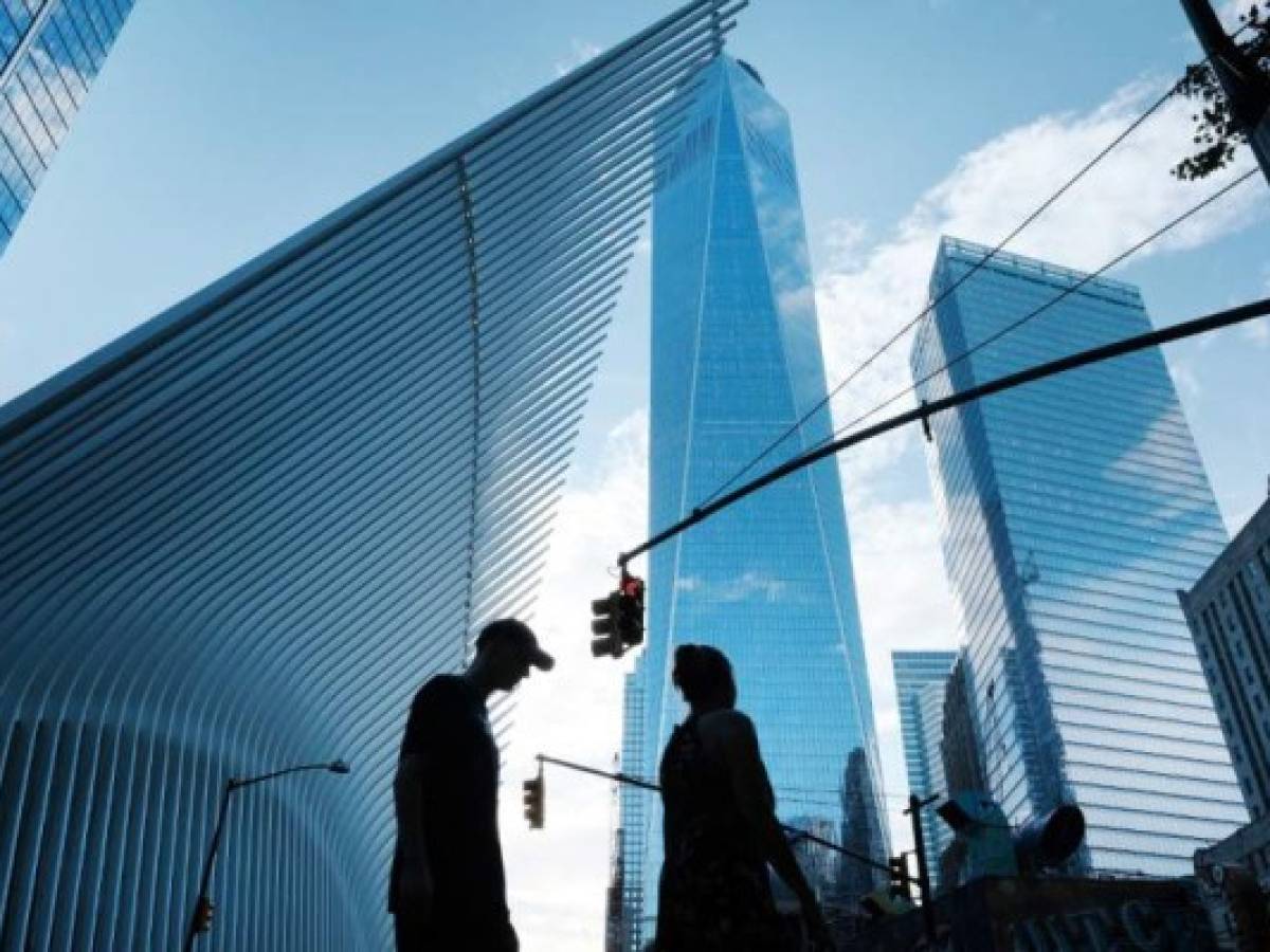 NEW YORK, NEW YORK - AUGUST 30: People walk near the sight of Ground Zero and the Freedom Tower on the day that the United States officially ended its participation in the war in Afghanistan on August 30, 2021 in New York City. The two-decade long conflict began shortly after the terrorist attacks of September 11, 2001 as the United States invaded the country to oust the Taliban for giving safe harbor to Al-Qaeda and the perpetrators of the terrorist attacks in both New York and Washington. Nearly 20 years later the Taliban have returned to control Afghanistan. Almost 2,500 U.S. service members have died in the conflict, and thousands of Afghan troops, police personnel and civilians have also been killed. Spencer Platt/Getty Images/AFP (Photo by SPENCER PLATT / GETTY IMAGES NORTH AMERICA / Getty Images via AFP)
