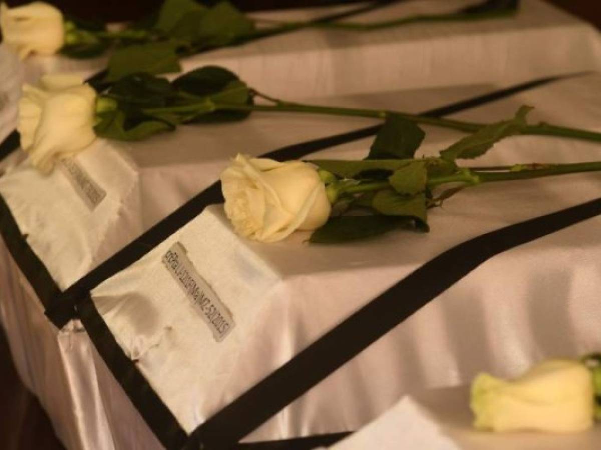 Coffins with the remains of six children, victims of the 1981 El Mozote massacre, are lined up to be handed over to their relatives in San Salvador, on December 6, 2017. The Institute of Legal Medicine of El Salvador handed over the exhumed remains of victims of the slaughter of El Mozote, following mitochondrial DNA tests. In December 1981, members of the US-trained Salvadorean elite Atlacatl battalion killed more than a thousand peasants during counter-insurgency operations in an episode known as the El Mozote Slaughter. / AFP PHOTO / MARVIN RECINOS