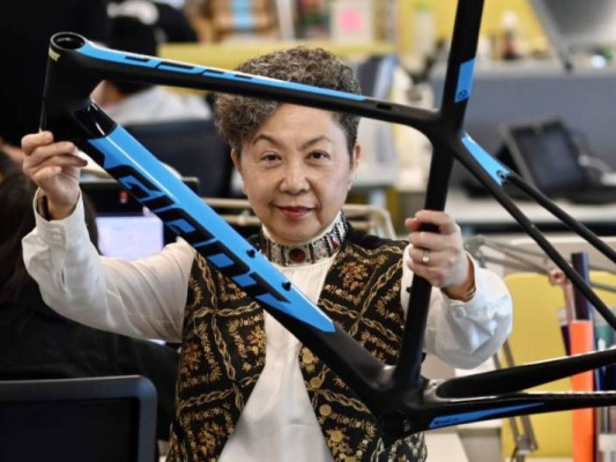 This photo taken on June 5, 2020 shows Bonnie Tu, the CEO of Giant Manufacturing Co. - the world's largest bicycle manufacturer - posing with a bike frame at the company's headquarters in the central Taiwanese city of Taichung. - Deserted streets, cabin-fever and worries over COVID-19-enabling commutes in Europe and the US have sent demand for bikes into high gear - with factories in Taiwan racing to push out new machines and scrambling to find parts. (Photo by Sam Yeh / AFP) / TO GO WITH Health-virus-Taiwan-Europe-US-industry-bicycle,FOCUS by Sean Chang and Amber Wang