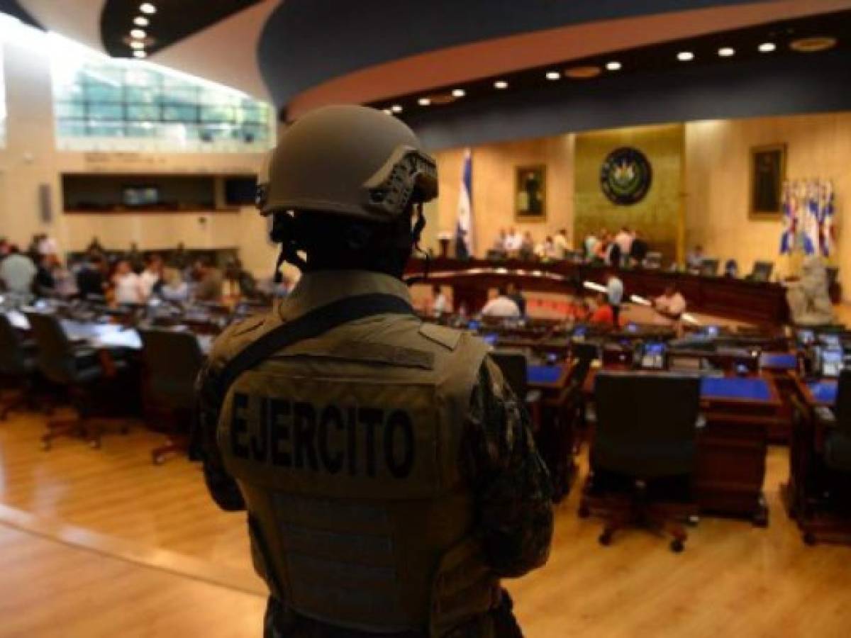 Members of the Salvadoran Armed Forces are seen within the Legislative Assembly during a protest outside the Legislative Assembly to make pressure on deputies to approve a loan to invest in security, in San Salvador on February 9, 2020. (Photo by STR / AFP)