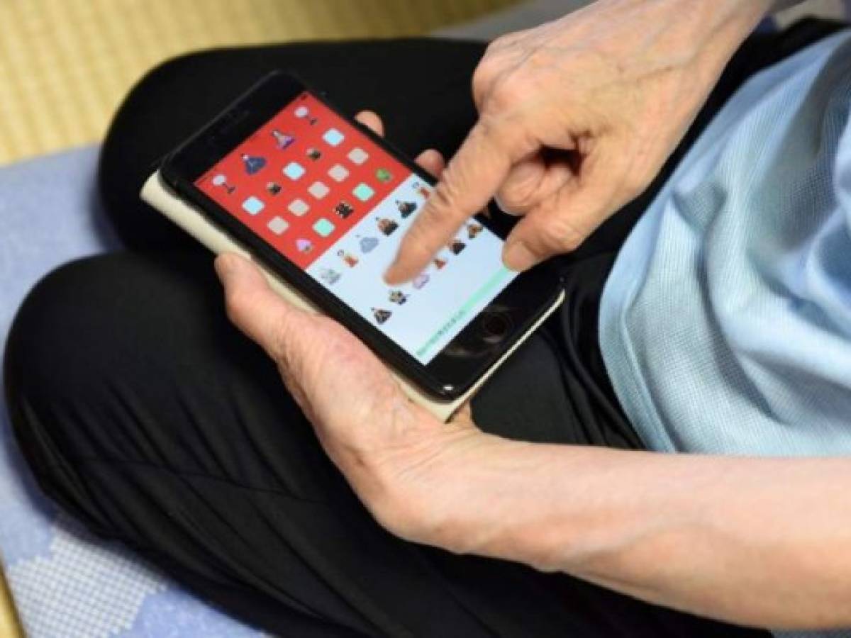 This picture taken on July 13, 2017 shows 82-year-old programmer Masako Wakamiya using the app game 'Hinadan' she developed in her home in Fujisawa, Kanagawa prefecture.When 82-year-old Masako Wakamiya first began working she still used an abacus for maths -- today she is one of the world's oldest iPhone app developers, a trailblazer in making smartphones accessible for the elderly. / AFP PHOTO / Kazuhiro NOGI / TO GO WITH Japan-tech-elderly,FEATURE by Karyn NISHIMURA-POUPEE