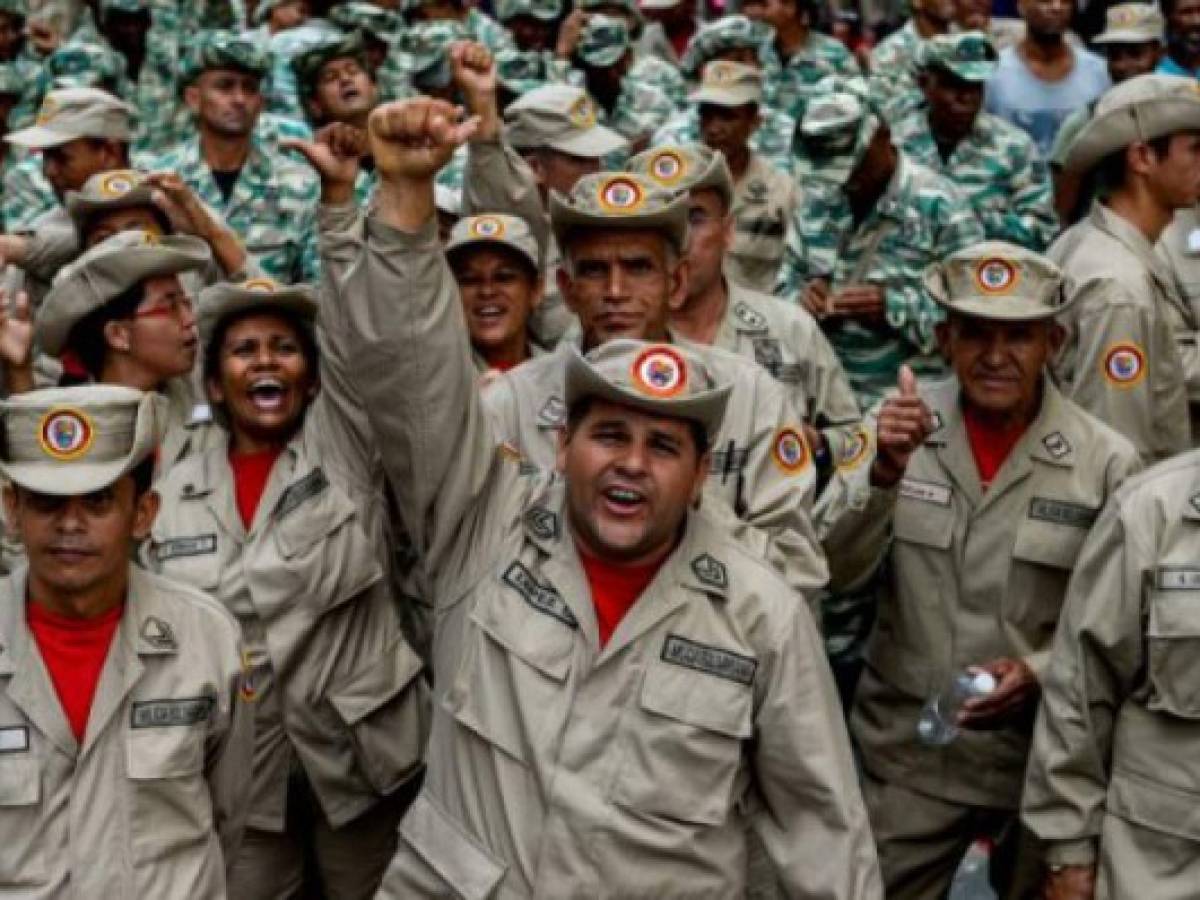 Members of the Bolivarian Militia take part in a parade in the framework of the seventh anniversary of the force, in front of the Miraflores presidential palace in Caracas on April 17, 2017.Venezuela's defence minister on Monday declared the army's loyalty to Maduro, who ordered troops into the streets ahead of a major protest by opponents trying to oust him. Venezuela is bracing for what Maduro's opponents vow will be the 'mother of all protests' Wednesday, after two weeks of violent demos against moves by the leftist leader and his allies to tighten their grip on power. / AFP PHOTO / Federico PARRA