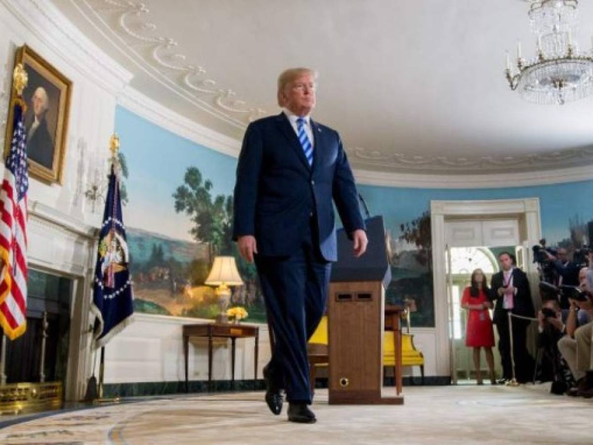 US President Donald Trump leaves after announcing his decision about the nuclear deal with Iran during a speech from the Diplomatic Reception Room at the White House in Washington, DC, May 8, 2018.Trump on Tuesday announced the US withdrawal from what he called the 'defective' multinational nuclear deal with Iran, and said Washington would reinstate sanctions against the Islamic republic. / AFP PHOTO / SAUL LOEB