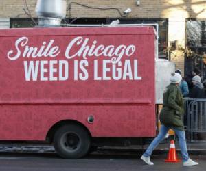 A food truck sits outside the Sunnyside Cannabis Dispensary as customers wait in line to buy marijuana, on January 1, 2020 in Chicago, Illinois. - On the first day of 2020, recreational marijuana became legal in Illinois, which joins 10 other US states with legal use of recreational marijuana. (Photo by KAMIL KRZACZYNSKI / AFP)