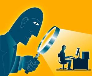 Large Man Looking At Co-Worker With A Magnifying Glass --- Image by © Images.com/Corbis