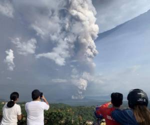 People take photos of a phreatic explosion from the Taal volcano as seen from the town of Tagaytay in Cavite province, southwest of Manila, on January 12, 2020. (Photo by Bullit MARQUEZ / AFP)